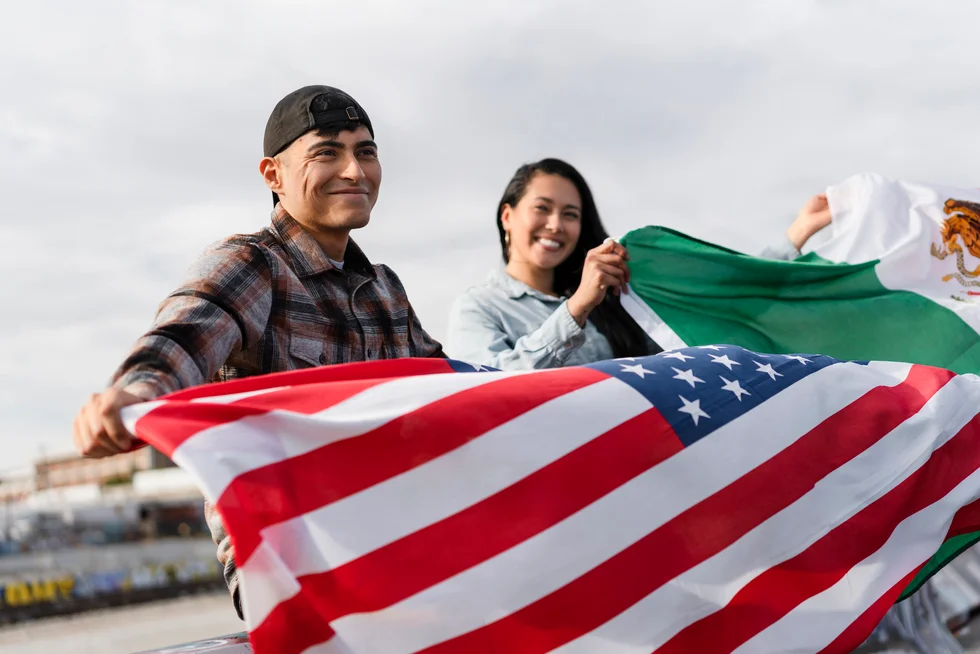 Couple holding the American flag after gaining citizenship in New Jersey.