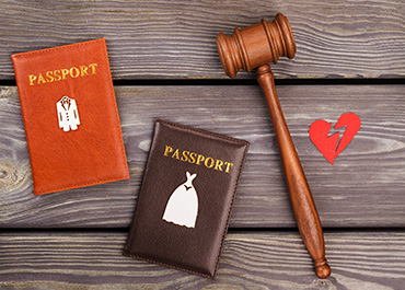 Passports, a gavel, and a broken heart representing complex international family law.