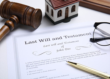 Last Will and Testament with a gavel and glasses for estate and probate legal services.