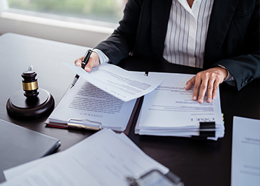 Attorney reviewing a Living Will, Last Will, and Durable Power of Attorney documents.