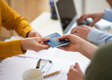 People exchanging identity documents for asylum claims based on specific social group membership.
