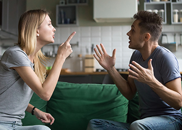 Couple arguing in a kitchen, representing contested divorce and family mediation.